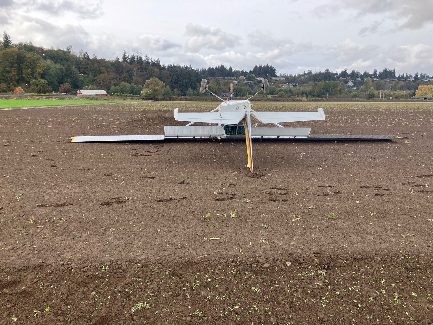 A small two-seater plane crash landed Wednesday afternoon and flipped onto its wings in a field southeast of Tacoma, in the Waller area of Pierce County, according to the Sheriff's Department.